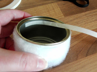 Place tape inside tin.
