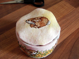 Place top stitched fabric onto can.